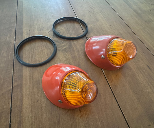 Bullet turn signal indicator units with orange Hella lenses.