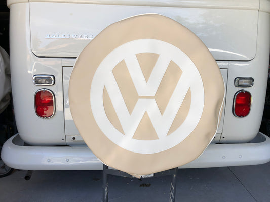 Spare wheel cover in light beige with white logo.